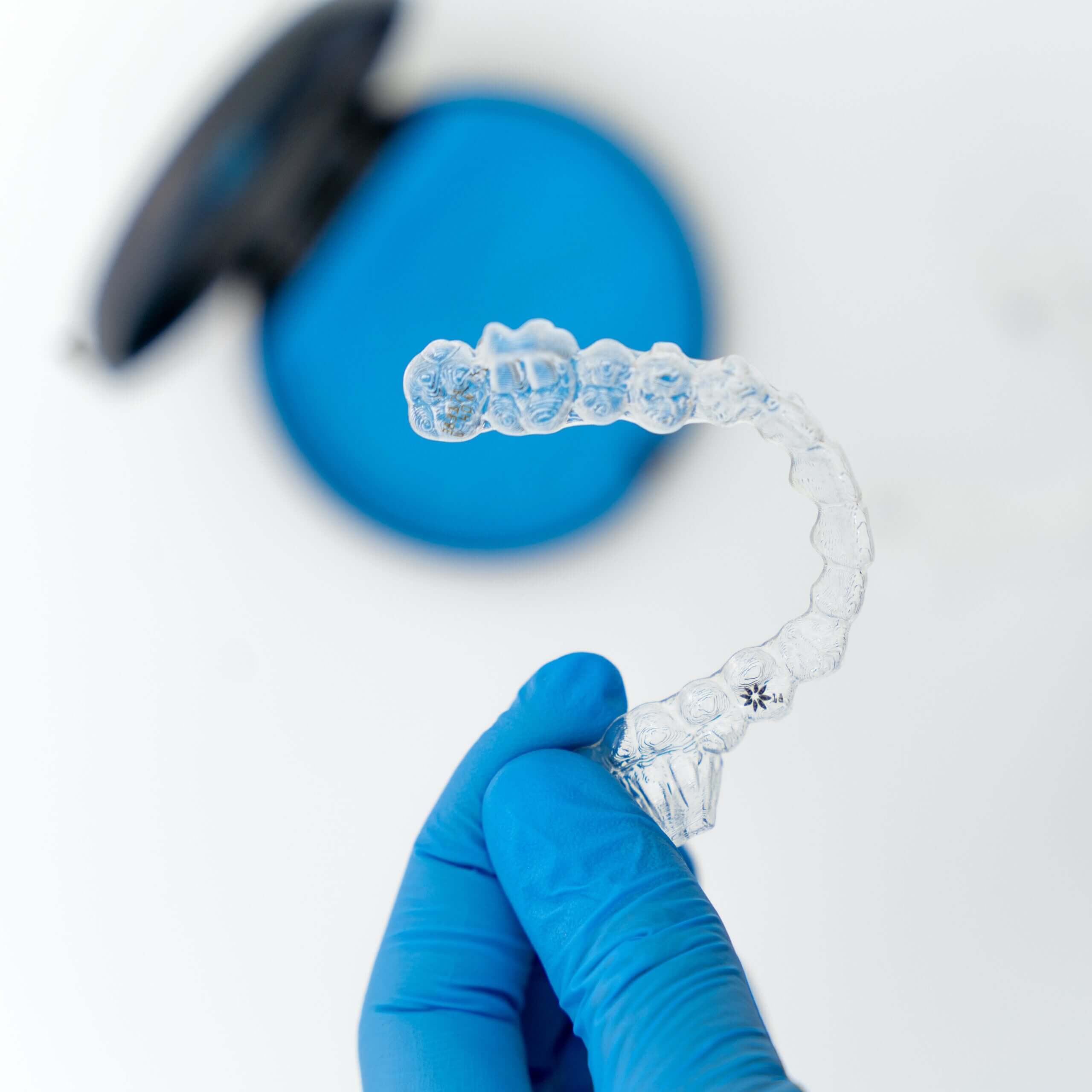 A pair of clear, BPA-free Invisalign aligners showcasing their near-invisible appearance.